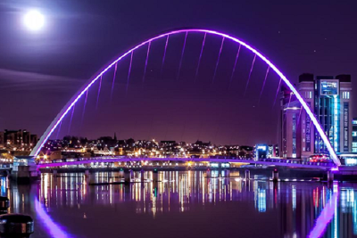 Gateshead Millennium Bridge lit purple